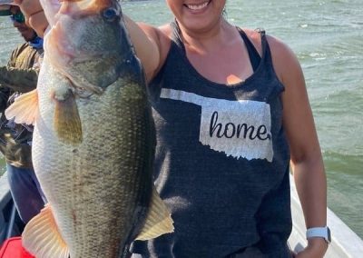 Angler reeling in largemouth bass on Mexican lake