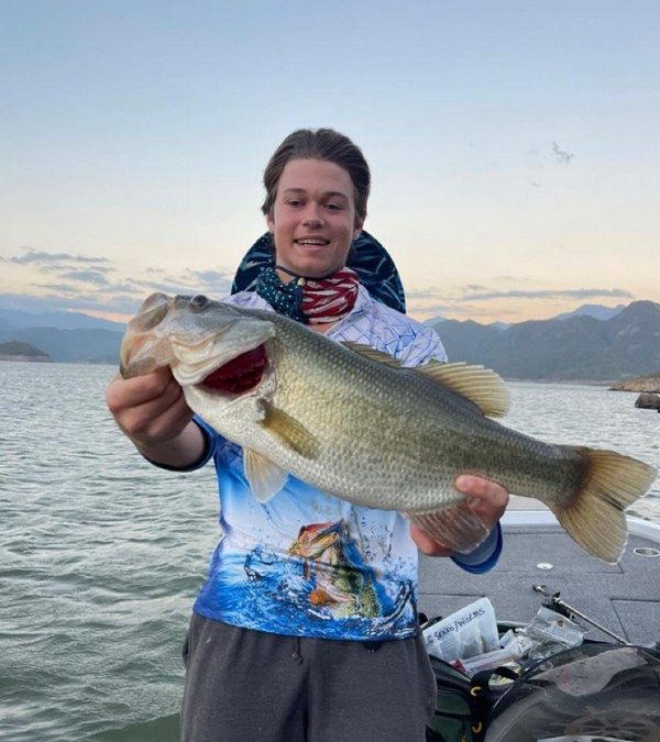 A young angler holding a Lake Aguamilpa bass.